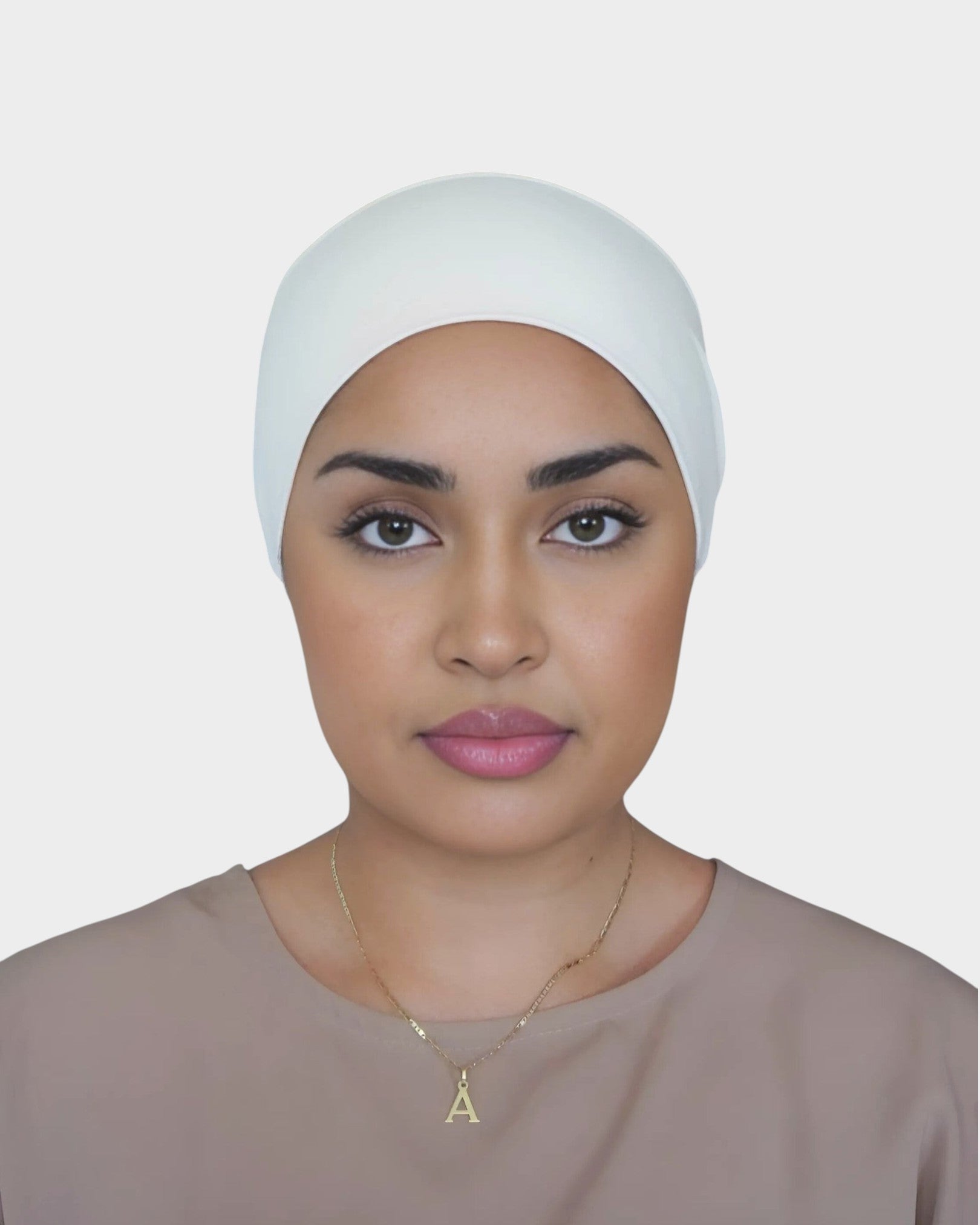 HIJABI LONDON cream 100% cotton tube undercap worn by a model for a smooth, bump-free hijab base.