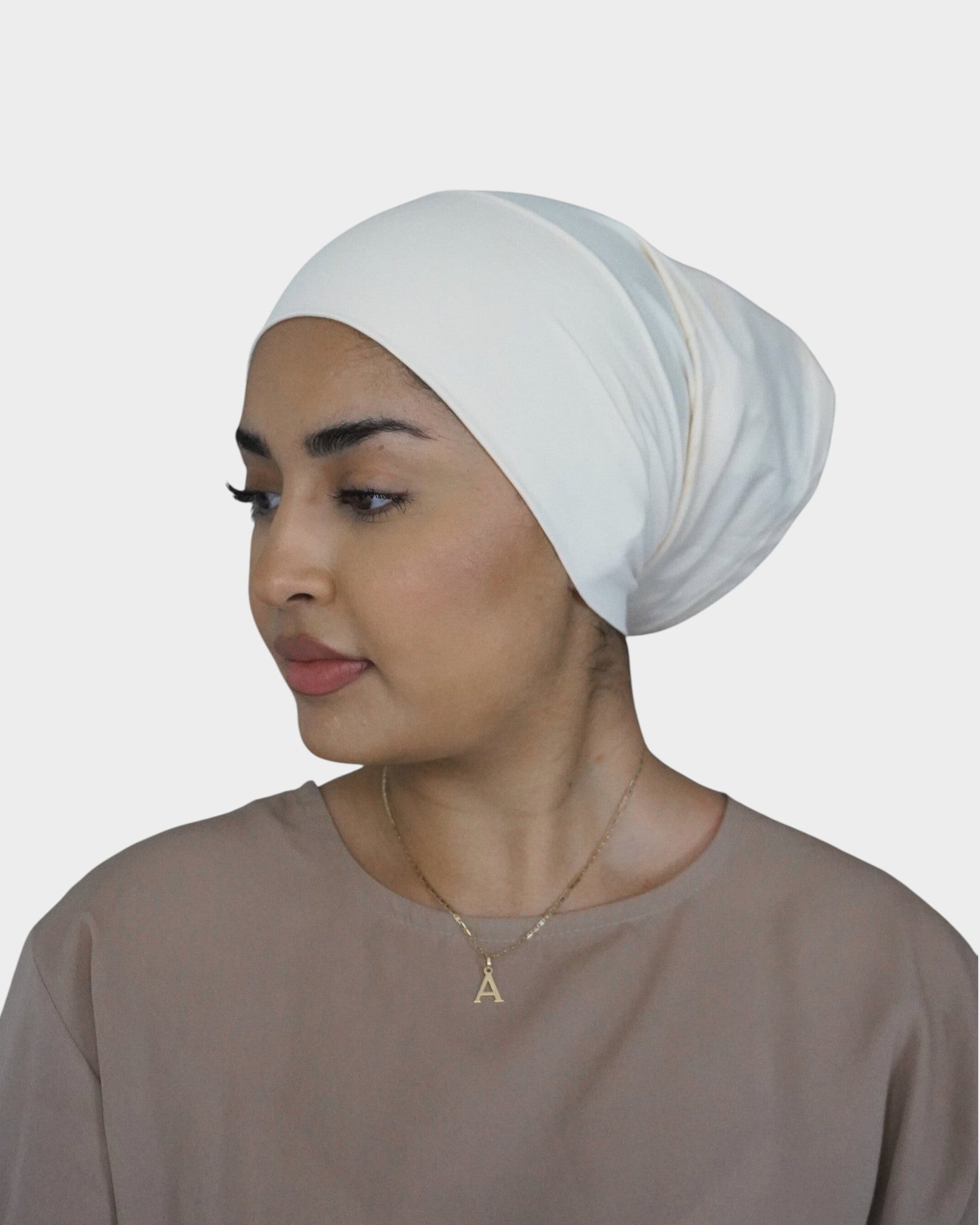 HIJABI LONDON cream 100% cotton tube undercap worn by a model for a smooth, bump-free hijab base.