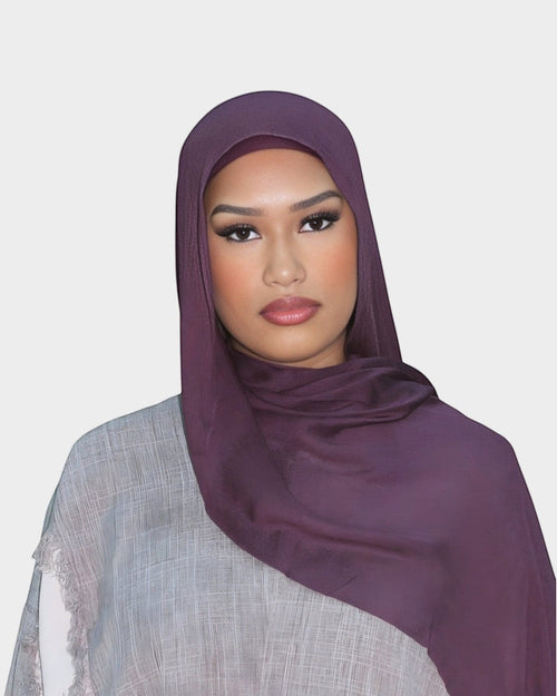 HIJABI LONDON aubergine modal hijab on a woman. Deep purple hijab with a soft plum undertone, crafted from 100% modal fabric.