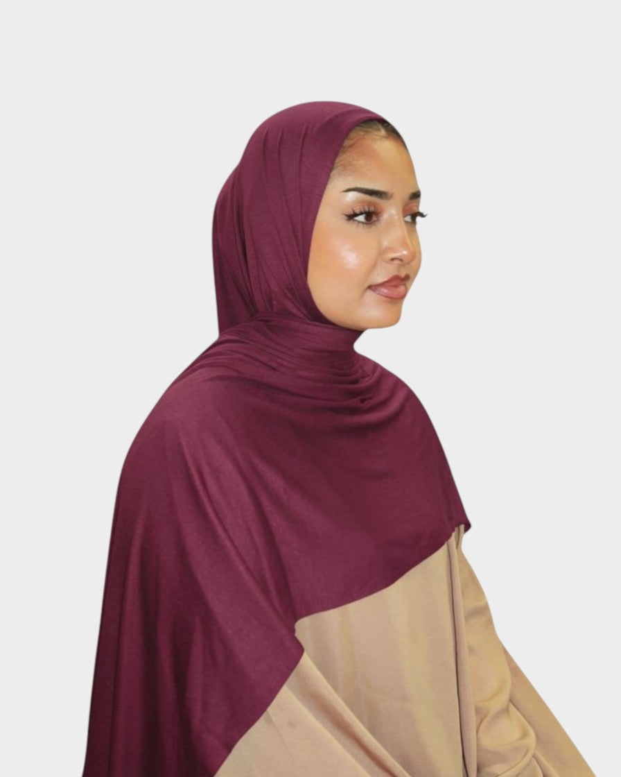 HIJABI LONDON burgundy premium jersey hijab draped on a model, offering comfort and versatile styling for any occasion.