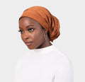 HIJABI LONDON camel faux suede turban wrap with a non-slip, one-size-fits-all design.