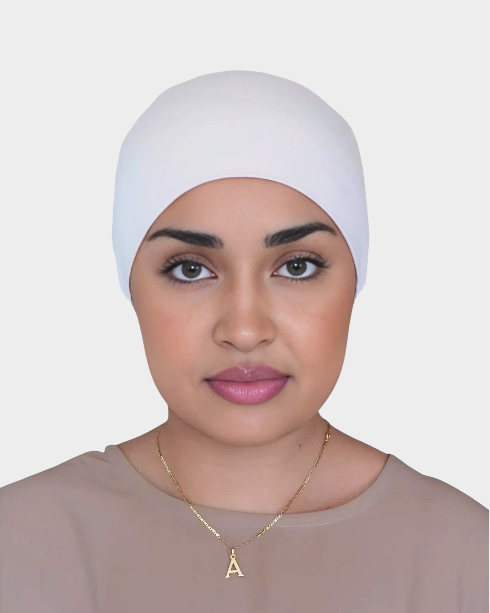 HIJABI LONDON cream tie back undercap made of soft, breathable cotton. Elasticated gathered design for secure fit.