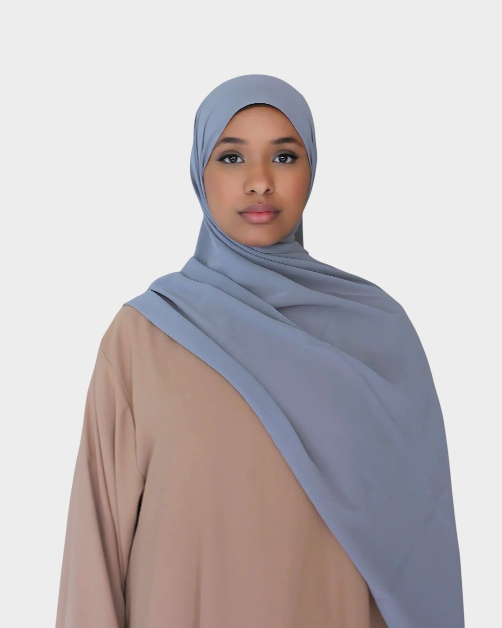 HIJABI LONDON medium grey chiffon hijab draped elegantly over a model wearing a tan abaya. Lightweight and breathable fabric.