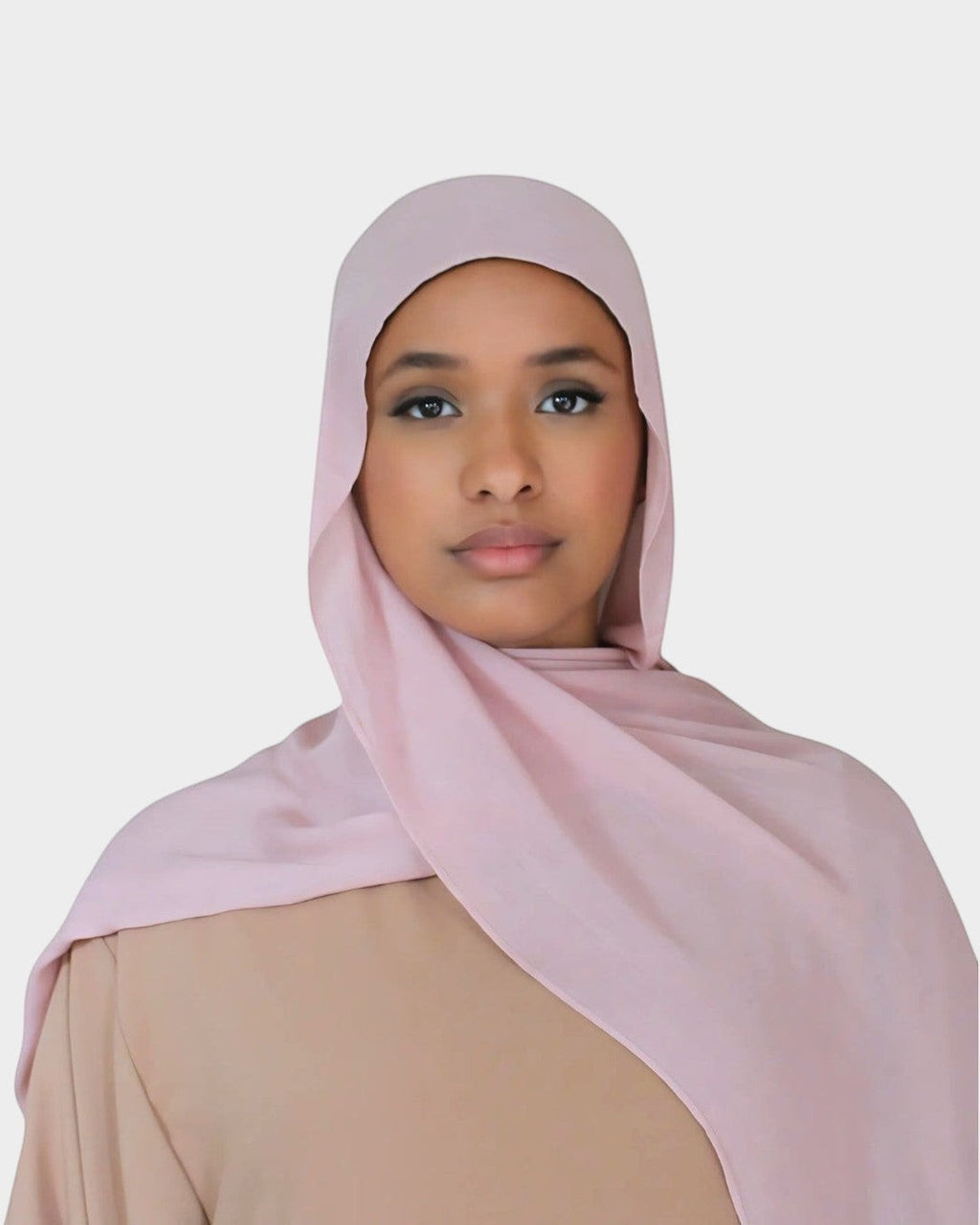 HIJABI LONDON light pink modal hijab worn by a woman. Ultra-soft, breathable fabric for all-day comfort.