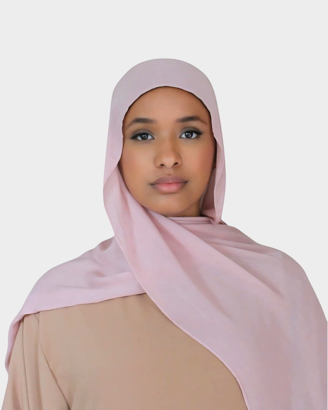 HIJABI LONDON light pink modal hijab worn by a woman. Ultra-soft, breathable fabric for all-day comfort.