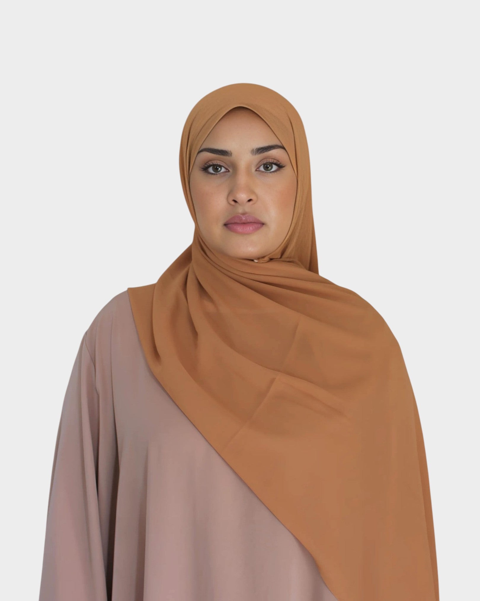 HIJABI LONDON tan chiffon hijab draped elegantly over a model wearing a beige abaya. Lightweight and breathable fabric.